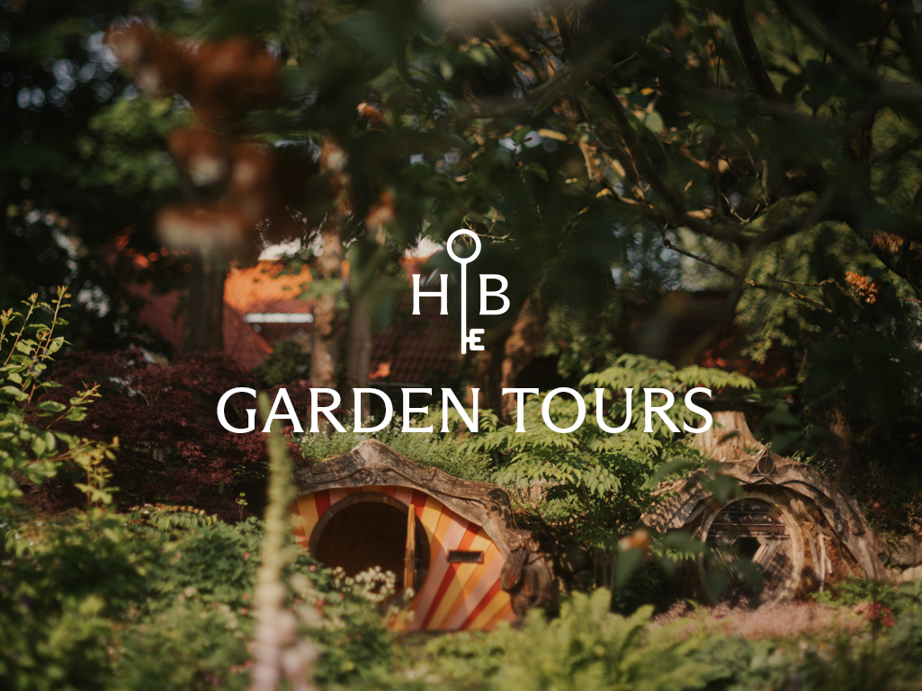 Garden tours logo with a hobbit-like house and trees in the background