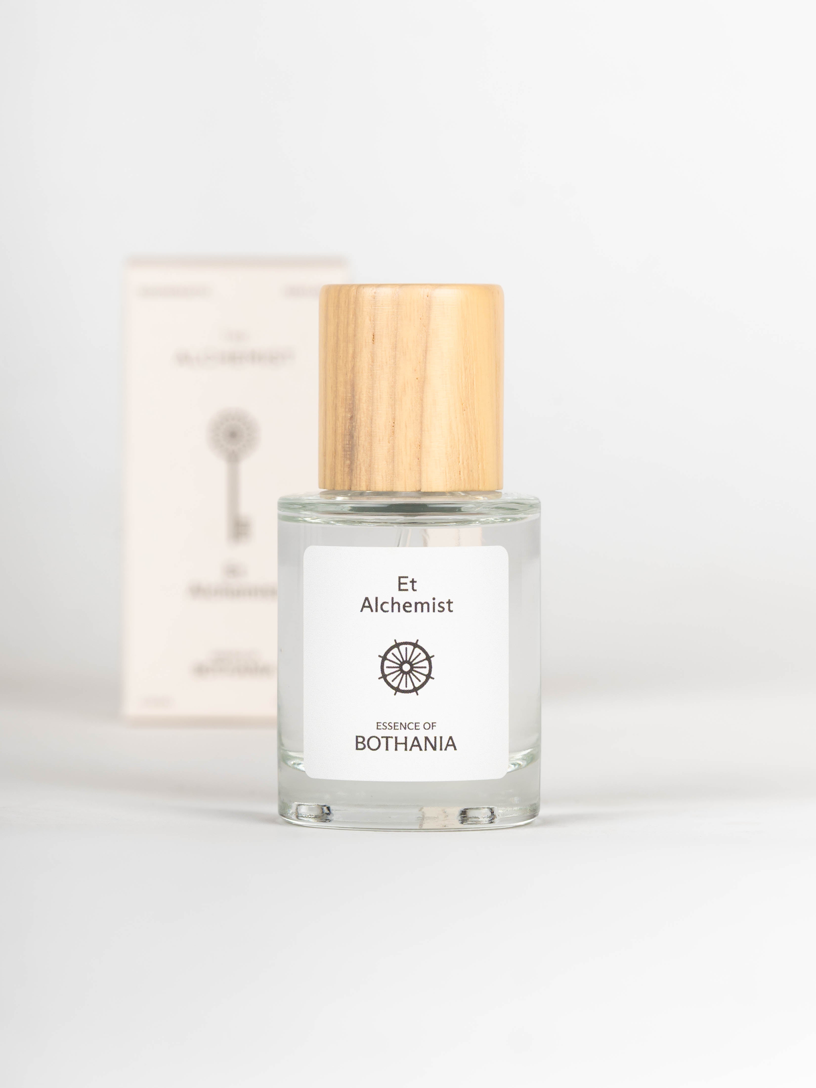 Bottle of Et Alchemist perfume with wooden cap on a white background