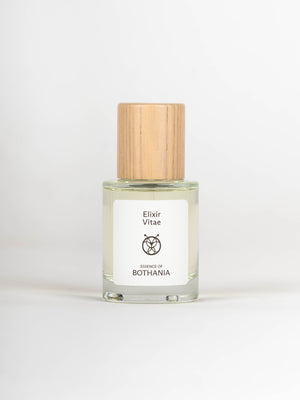 Glass bottle with wooden cap labeled 'Elixir Vitae' on a white background