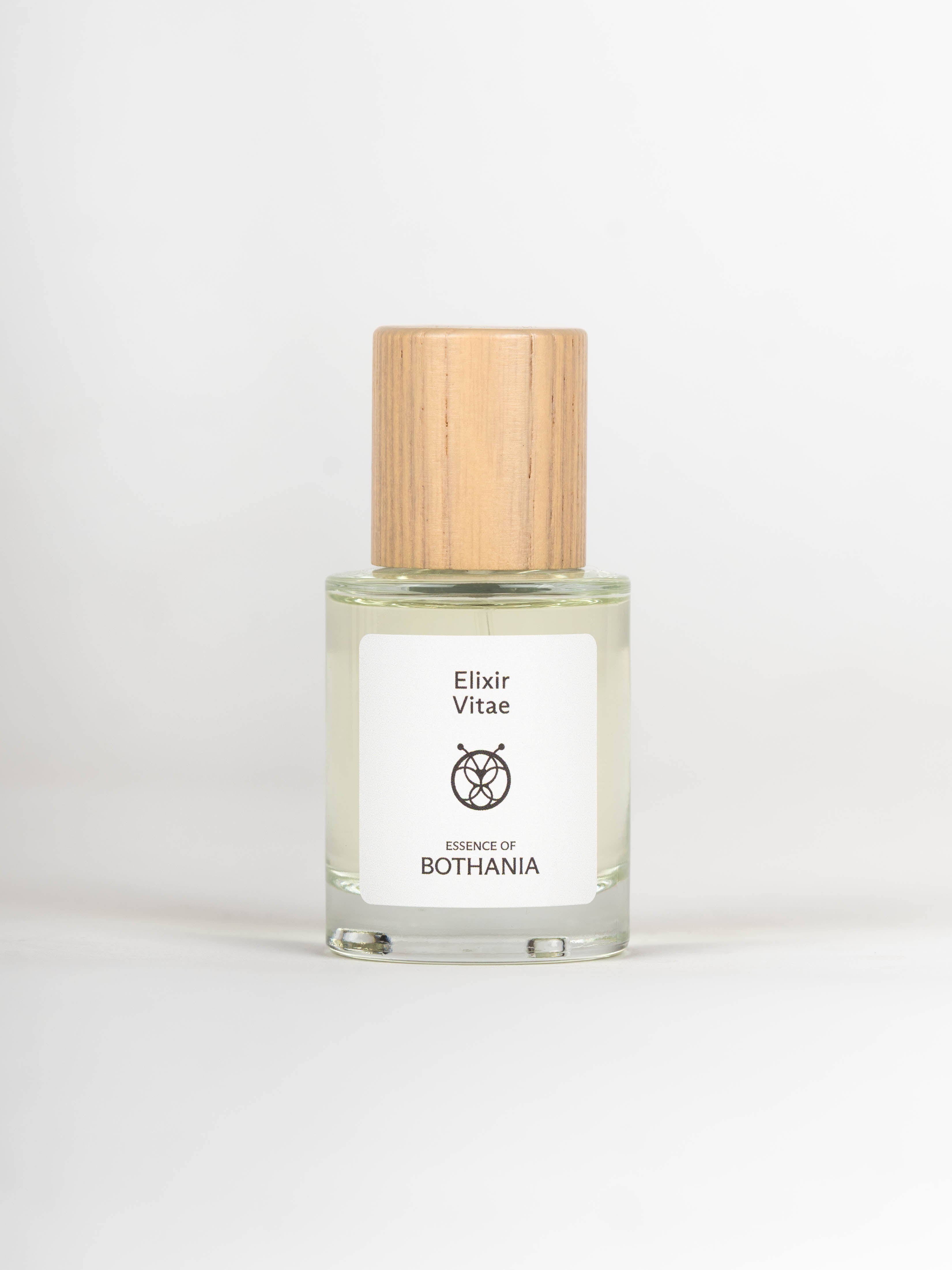 Glass bottle with wooden cap labeled 'Elixir Vitae' on a white background