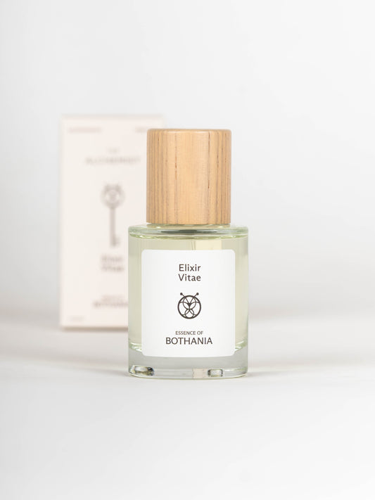 Clear glass bottle with wooden cap labeled 'Elixir Vitae' on a white background