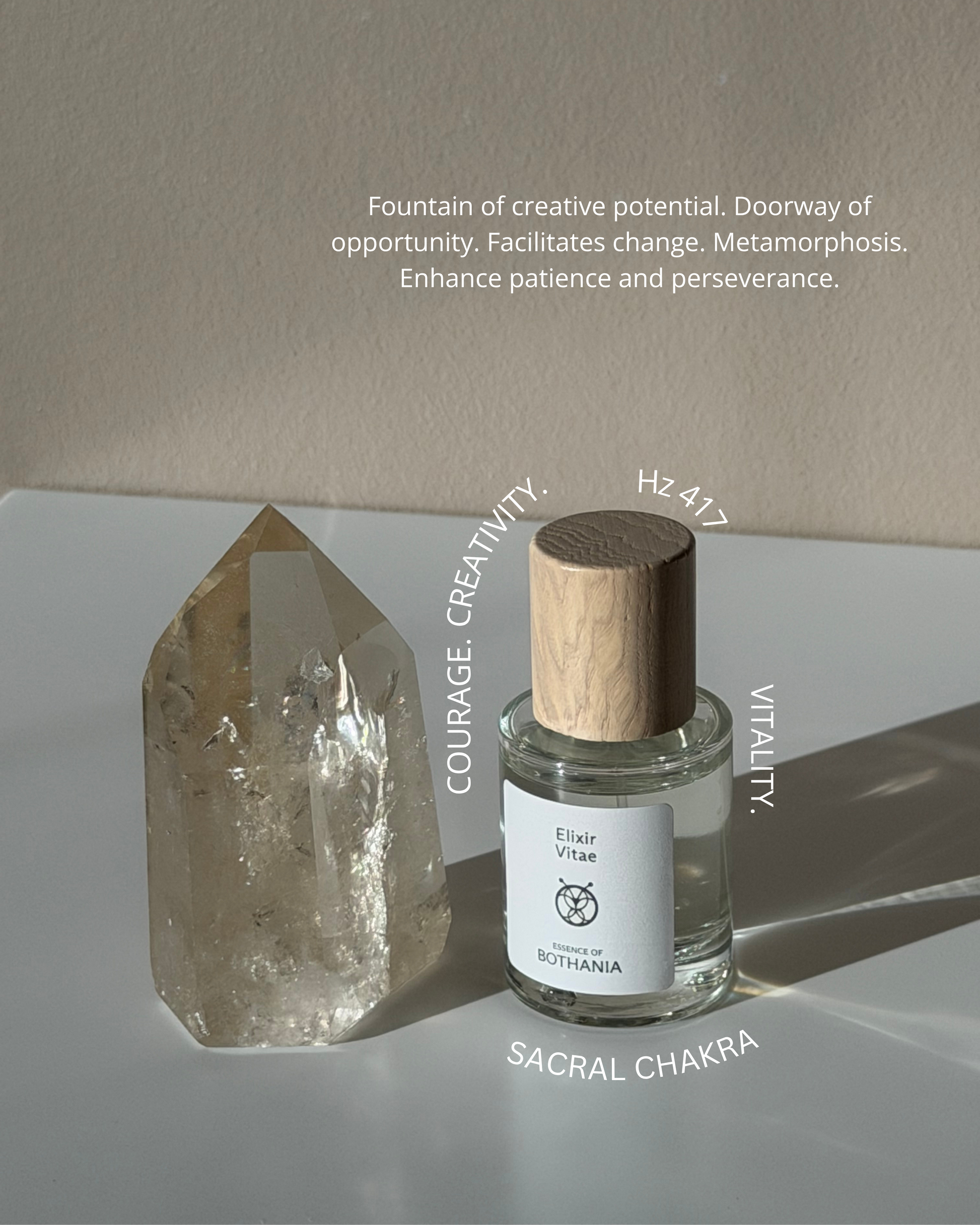 Bio-energetic Perfume Spray 'Elixir Vitae' made by House of Bothania. Glass bottle with wood cap, light background. Crystal palced beside the perfume. Text overlaying the picture with the frequency of the perfume, and it's emotional benefits.