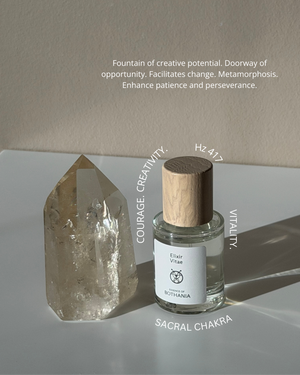 Bio-energetic Perfume Spray 'Elixir Vitae' made by House of Bothania. Glass bottle with wood cap, light background. Crystal palced beside the perfume. Text overlaying the picture with the frequency of the perfume, and it's emotional benefits.