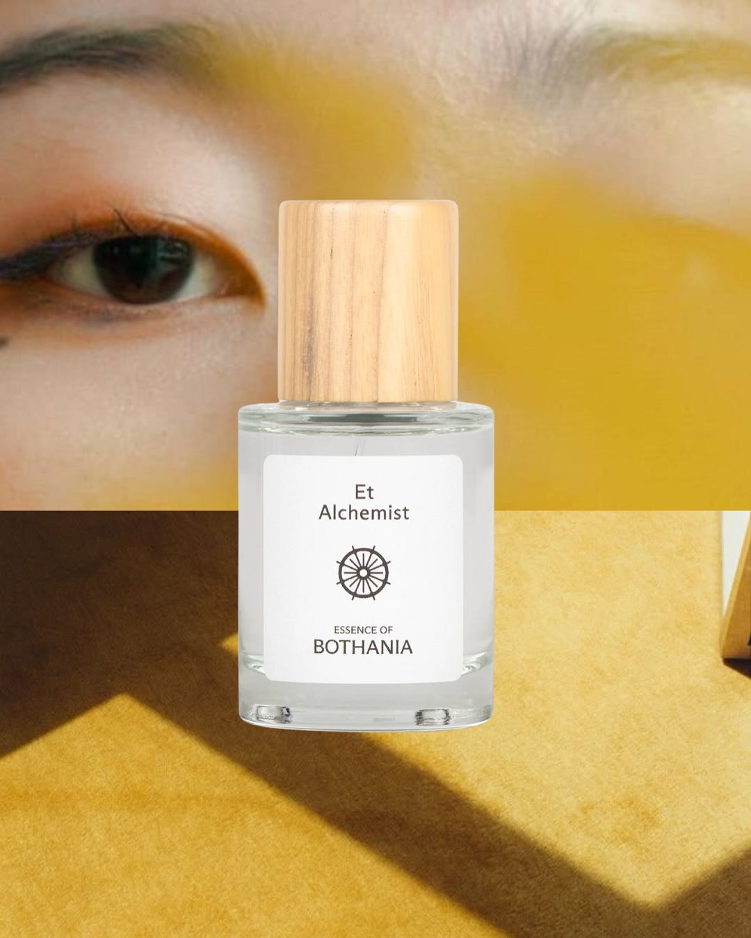 Bottle of Et Alchemist made by House of Bothania — with a wooden cap on a yellow background. Bioenergetic perfume made to awaken your senses. Activates self-power, your solar plexus chakra. 